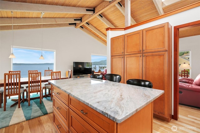 451 Beach Dr, Sequim, WA 98382 - kitchen with light wood finished floors, wooden ceiling, a center island, light stone counters, and hanging light fixtures
