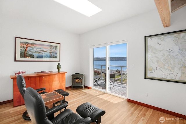 451 Beach Dr, Sequim, WA 98382 - home office with a wood stove, a water view, and wood finished floors