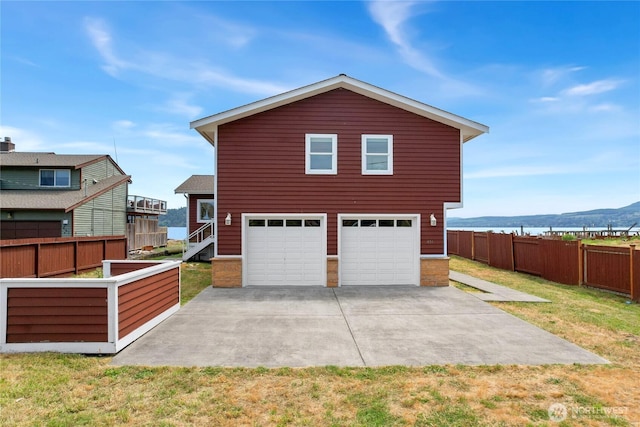 451 Beach Dr, Sequim, WA 98382 - view of property exterior with a garage, concrete driveway, and a mountain view