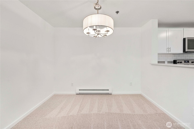 975 Aberdeen Ave NE Unit C306, Renton, WA 98056 - unfurnished dining area featuring a baseboard heating unit, carpet, and a chandelier