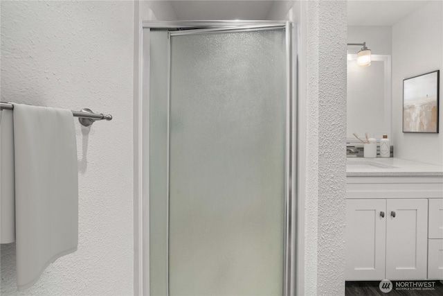 975 Aberdeen Ave NE Unit C306, Renton, WA 98056 - bathroom featuring a stall shower, vanity, and a textured wall