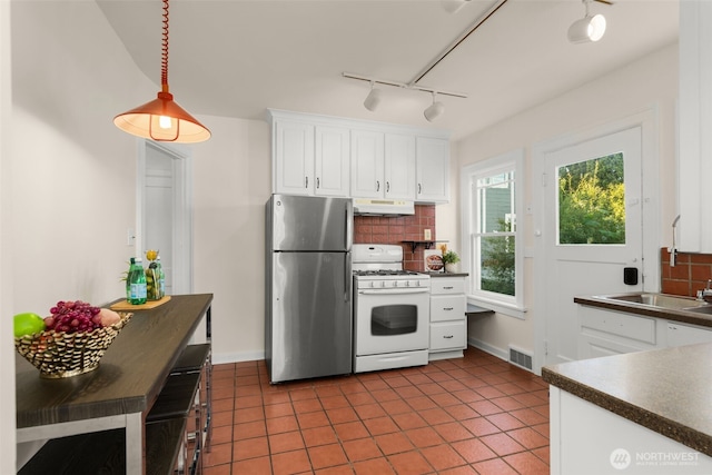 5803 Latona Ave NE, Seattle, WA 98105 - kitchen with freestanding refrigerator, white gas range oven, under cabinet range hood, rail lighting, and dark countertops