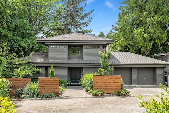 5115 NE Latimer Pl, Seattle, WA 98105 - view of front facade with concrete driveway, a shingled roof, and an attached garage
