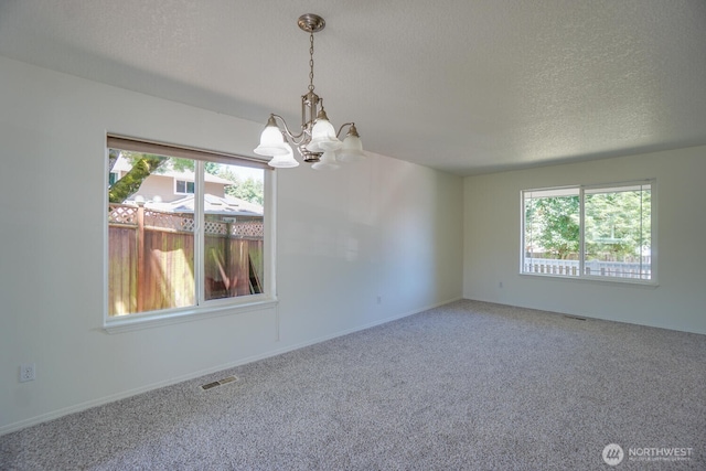 3300 NE 90th Cir, Vancouver, WA 98665 - empty room featuring a chandelier, healthy amount of natural light, a textured ceiling, and carpet flooring