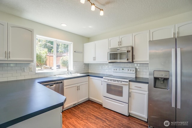 3300 NE 90th Cir, Vancouver, WA 98665 - kitchen with stainless steel appliances, dark countertops, white cabinets, a textured ceiling, and dark wood-type flooring