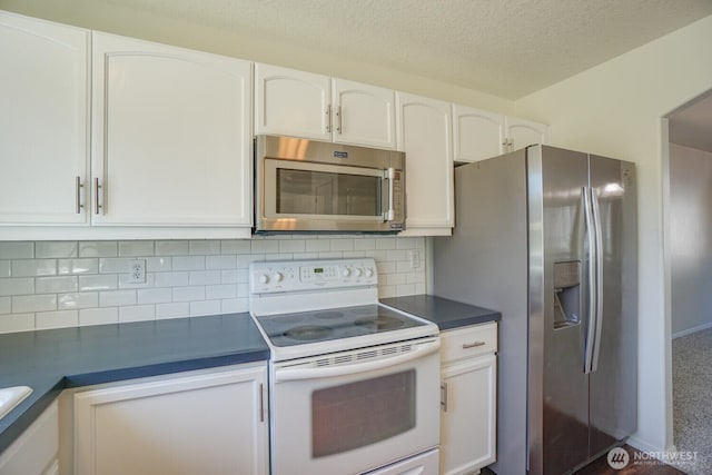 3300 NE 90th Cir, Vancouver, WA 98665 - kitchen with appliances with stainless steel finishes, dark countertops, white cabinets, backsplash, and a textured ceiling