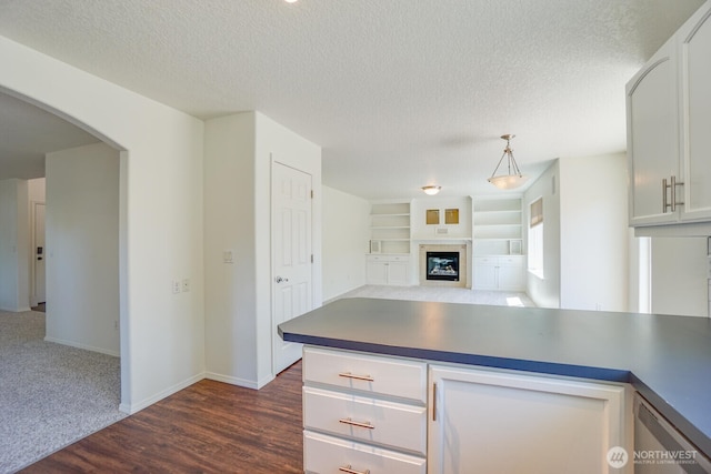 3300 NE 90th Cir, Vancouver, WA 98665 - kitchen featuring arched walkways, a textured ceiling, open floor plan, a fireplace, and white cabinets