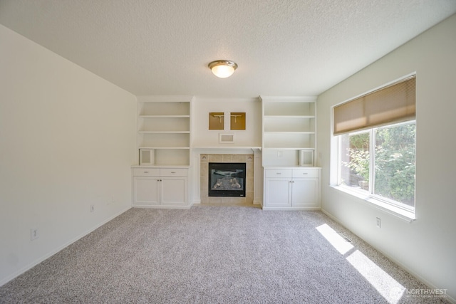 3300 NE 90th Cir, Vancouver, WA 98665 - unfurnished living room with a textured ceiling, a fireplace, light colored carpet, and built in shelves