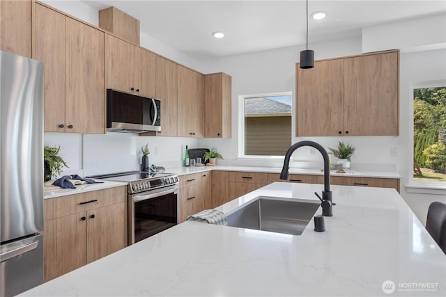 4710 Sagebrush Ln, Blaine, WA 98230 - kitchen with appliances with stainless steel finishes, hanging light fixtures, light stone counters, modern cabinets, and recessed lighting