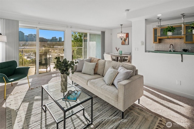 701 122nd Ave NE Unit 207, Bellevue, WA 98005 - carpeted living room with a chandelier and a skyline view