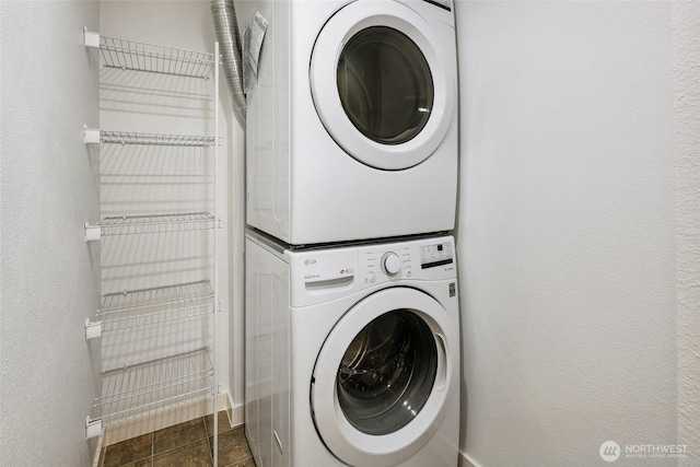 701 122nd Ave NE Unit 207, Bellevue, WA 98005 - laundry room featuring stacked washer and clothes dryer and a textured wall