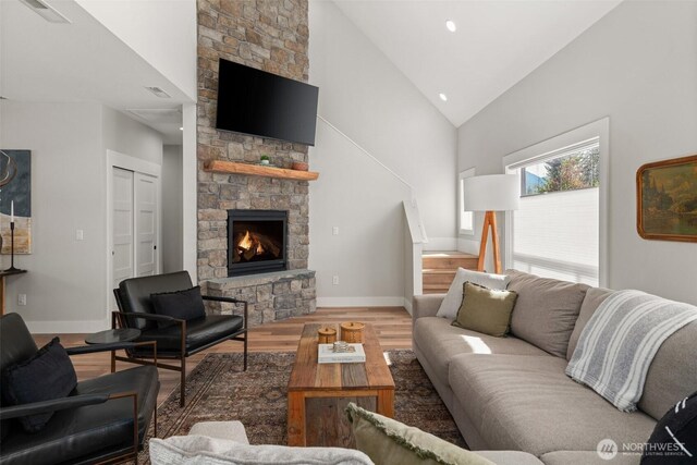 135 Main St E, Packwood, WA 98361 - living room featuring a stone fireplace, wood finished floors, high vaulted ceiling, and recessed lighting