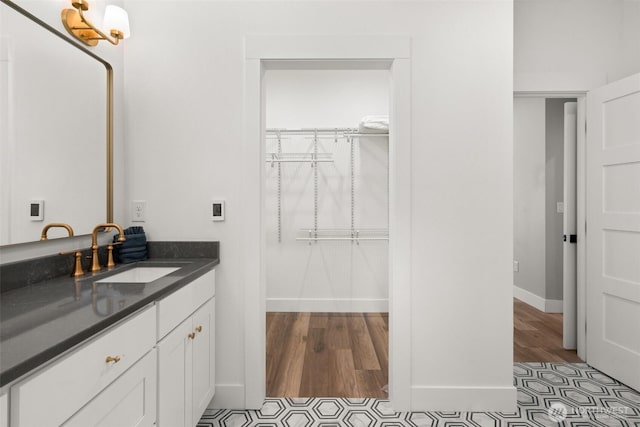 135 Main St E, Packwood, WA 98361 - bathroom with vanity, a spacious closet, and wood finished floors