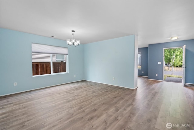 14933 Terra View St SE, Yelm, WA 98597 - empty room with a chandelier and wood finished floors