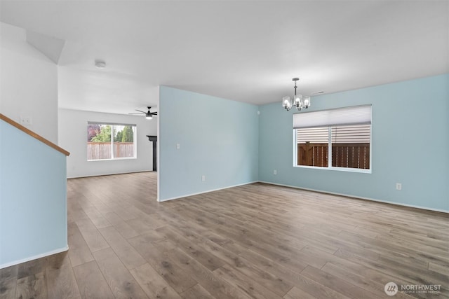 14933 Terra View St SE, Yelm, WA 98597 - unfurnished room featuring a chandelier, wood finished floors, and a ceiling fan