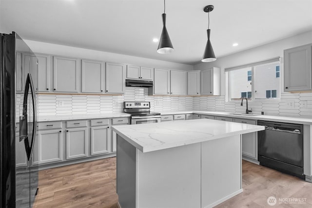 14933 Terra View St SE, Yelm, WA 98597 - kitchen with black appliances, under cabinet range hood, gray cabinets, decorative backsplash, and recessed lighting