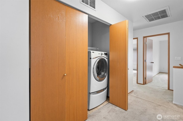 14933 Terra View St SE, Yelm, WA 98597 - laundry area featuring light carpet and washer / clothes dryer
