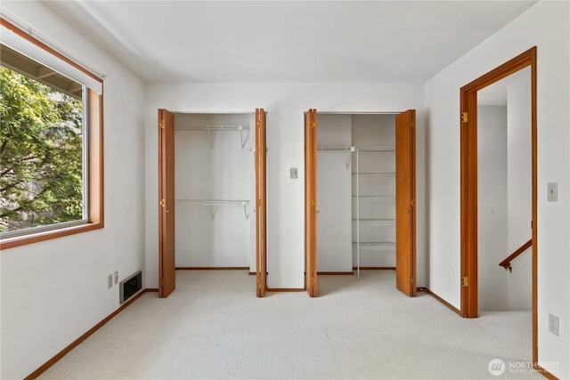 18910 Bothell Everett Hwy Unit K3, Bothell, WA 98012 - unfurnished bedroom featuring multiple closets and carpet flooring