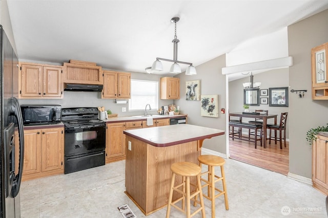 16420 SE 269th St SE, Covington, WA 98042 - kitchen featuring black appliances, under cabinet range hood, a kitchen bar, lofted ceiling, and a center island