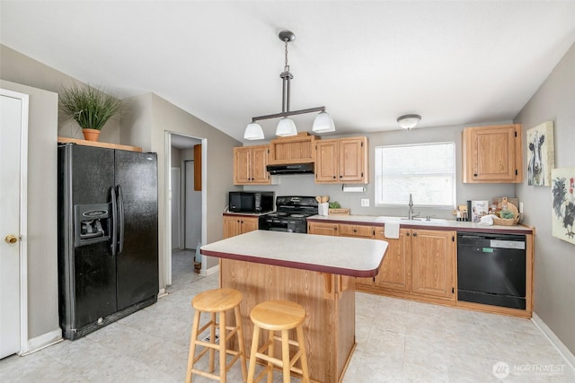 16420 SE 269th St SE, Covington, WA 98042 - kitchen with black appliances, under cabinet range hood, light countertops, vaulted ceiling, and a kitchen breakfast bar