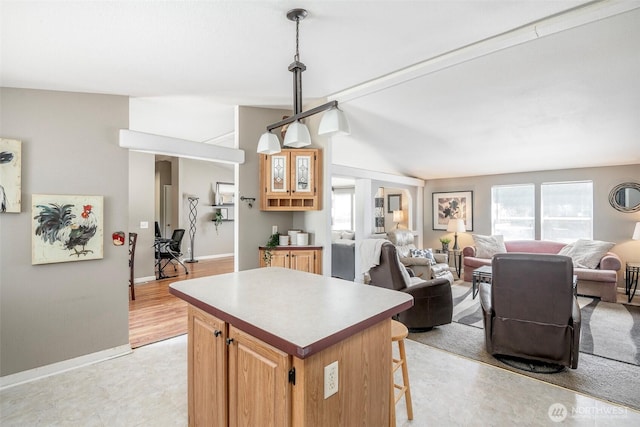 16420 SE 269th St SE, Covington, WA 98042 - kitchen featuring a kitchen island, a kitchen bar, open floor plan, hanging light fixtures, and lofted ceiling