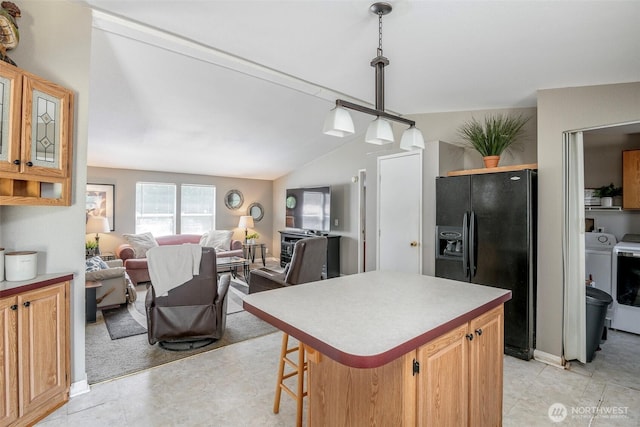 16420 SE 269th St SE, Covington, WA 98042 - kitchen featuring black fridge with ice dispenser, open floor plan, vaulted ceiling, a center island, and light countertops