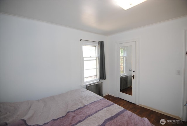 130 S 108th Pl, Seattle, WA 98168 - bedroom featuring radiator heating unit and dark wood finished floors