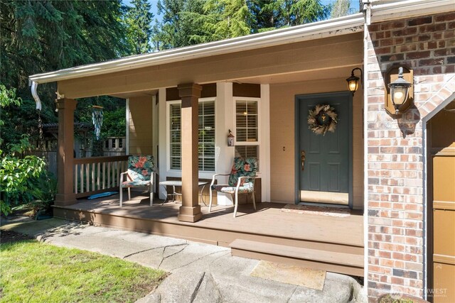 7829 197th Ave E, Bonney Lake, WA 98391 - doorway to property featuring a porch and brick siding