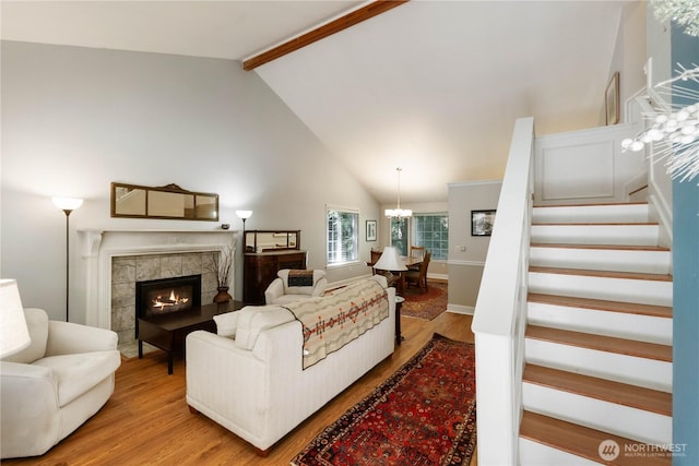 7829 197th Ave E, Bonney Lake, WA 98391 - living area featuring wood finished floors, stairway, a tiled fireplace, and a chandelier