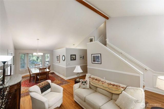 7829 197th Ave E, Bonney Lake, WA 98391 - living area featuring wood finished floors, a chandelier, and stairway