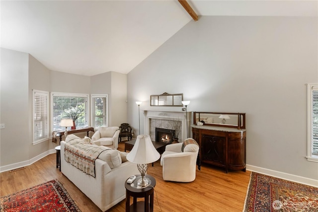 7829 197th Ave E, Bonney Lake, WA 98391 - living room with light wood-type flooring, a tile fireplace, beamed ceiling, and high vaulted ceiling