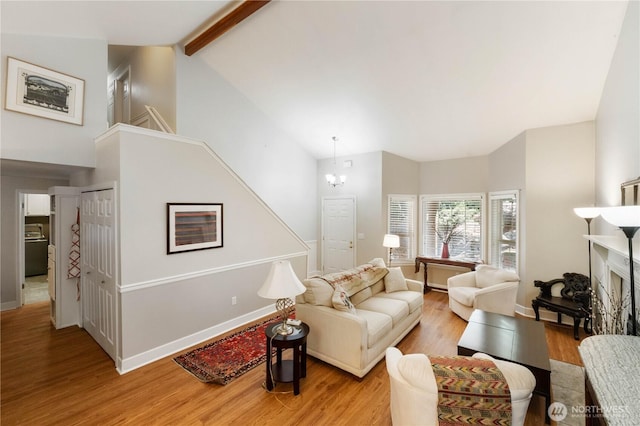 7829 197th Ave E, Bonney Lake, WA 98391 - living room with light wood-style flooring, a fireplace, high vaulted ceiling, a chandelier, and stairway