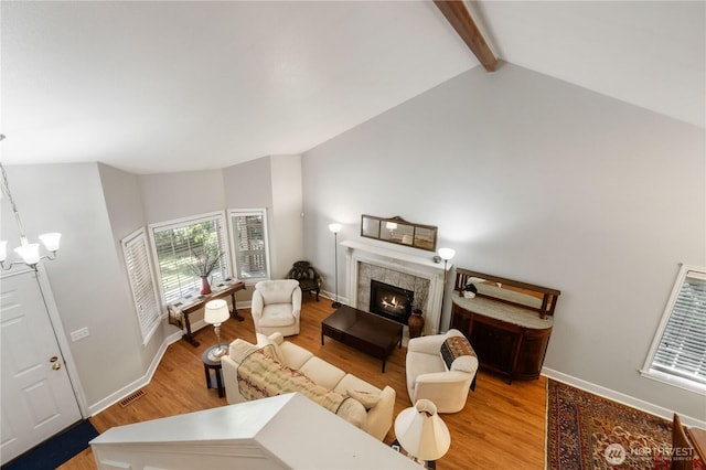 7829 197th Ave E, Bonney Lake, WA 98391 - living area featuring light wood-style floors, a tile fireplace, and a chandelier