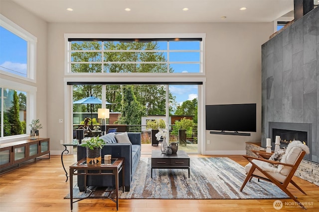 1808 2nd St, Kirkland, WA 98033 - living area with healthy amount of natural light, a high ceiling, recessed lighting, wood finished floors, and a fireplace