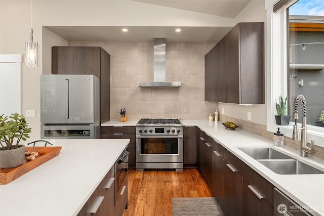 1808 2nd St, Kirkland, WA 98033 - kitchen with high end stainless steel range, freestanding refrigerator, wall chimney exhaust hood, dishwashing machine, and light countertops