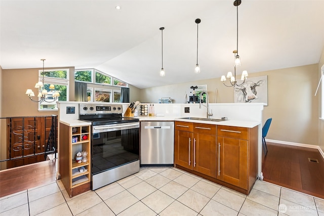 4201 SW 328th Ct, Federal Way, WA 98023 - kitchen with appliances with stainless steel finishes, a chandelier, vaulted ceiling, brown cabinetry, and light countertops