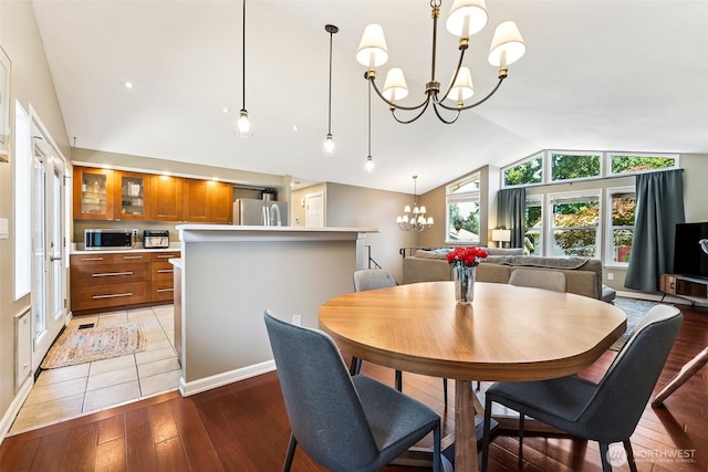4201 SW 328th Ct, Federal Way, WA 98023 - dining room with a chandelier, vaulted ceiling, and light wood-type flooring