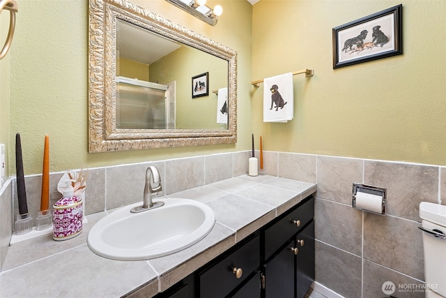 4201 SW 328th Ct, Federal Way, WA 98023 - bathroom featuring vanity, tile walls, and a shower with door