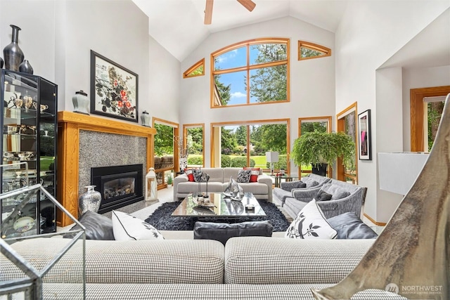 8834 Goldeneye Ln, Blaine, WA 98230 - living area with ceiling fan, high vaulted ceiling, and a glass covered fireplace