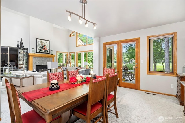 8834 Goldeneye Ln, Blaine, WA 98230 - dining room featuring light colored carpet and a glass covered fireplace