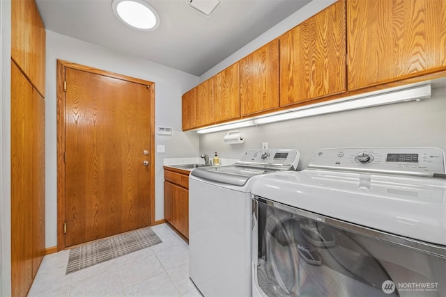 8834 Goldeneye Ln, Blaine, WA 98230 - laundry room featuring washer and clothes dryer, cabinet space, and light tile patterned floors