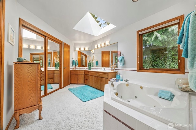 8834 Goldeneye Ln, Blaine, WA 98230 - full bathroom featuring a skylight, double vanity, and a whirlpool tub
