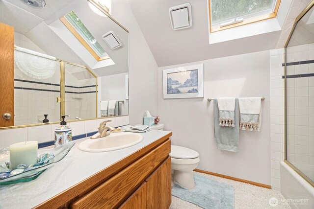 8834 Goldeneye Ln, Blaine, WA 98230 - bathroom with a skylight, vaulted ceiling, vanity, and shower / bath combination with glass door