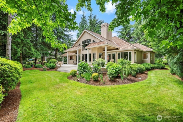 8834 Goldeneye Ln, Blaine, WA 98230 - rear view of house with a chimney and a yard