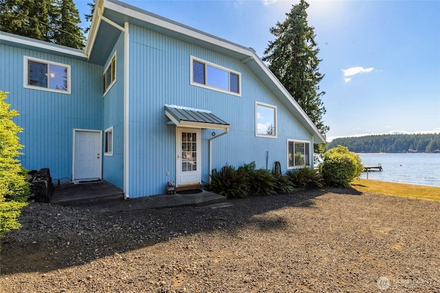 1171 E Mason Lake Dr E, Grapeview, WA 98546 - rear view of house with a water view, a metal roof, and a standing seam roof