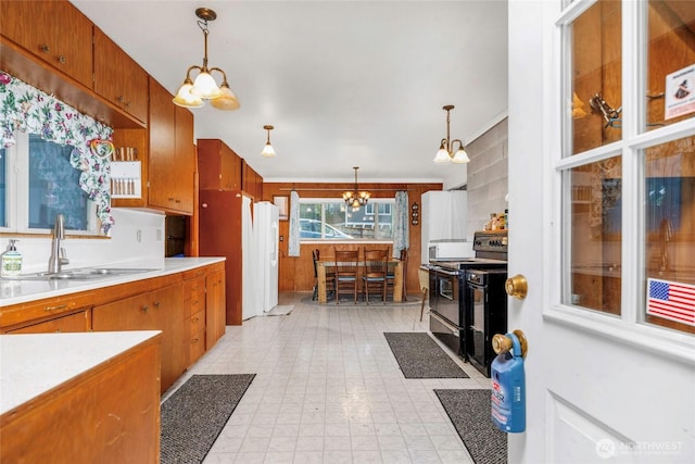 1171 E Mason Lake Dr E, Grapeview, WA 98546 - kitchen featuring range with electric cooktop, a chandelier, light countertops, and brown cabinets