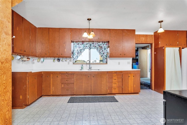1171 E Mason Lake Dr E, Grapeview, WA 98546 - kitchen featuring a chandelier, light countertops, brown cabinetry, and pendant lighting
