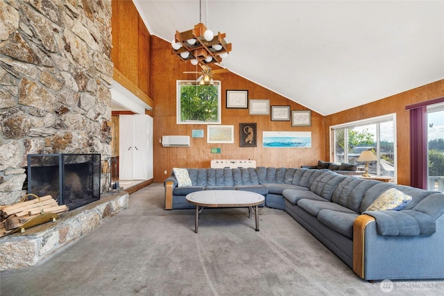 1171 E Mason Lake Dr E, Grapeview, WA 98546 - carpeted living room featuring wooden walls, vaulted ceiling, and a stone fireplace