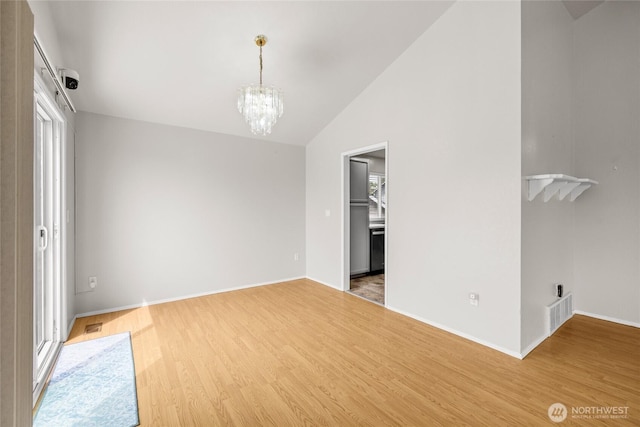 742 N 103rd St, Seattle, WA 98133 - unfurnished dining area with a chandelier, light wood-style flooring, and lofted ceiling