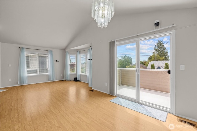 742 N 103rd St, Seattle, WA 98133 - spare room featuring a chandelier, light wood-type flooring, and high vaulted ceiling